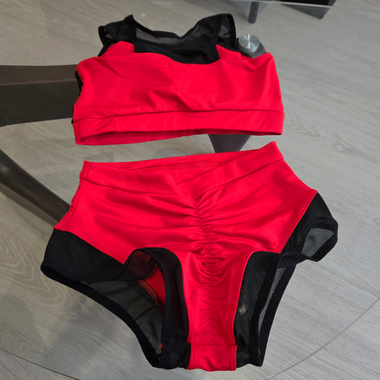 Pole dance costume with black translucent inserts on the top and bottom